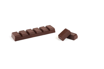 Close-up pieces of chocolate bar with filling isolated on white background.