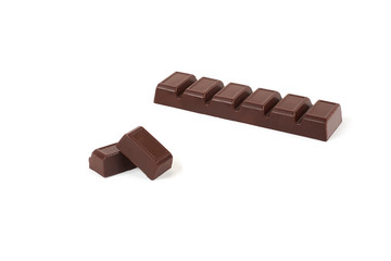 Close-up pieces of chocolate bar with filling isolated on white background.