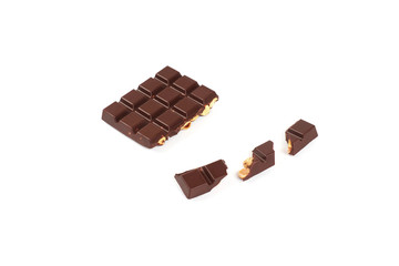 bar of dark chocolate with hazelnuts. Pieces of chocolate with nuts, isolated on white background.