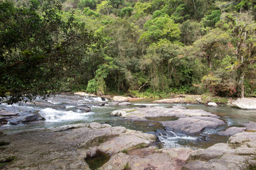 River with many rocks and small falls Water and forest on the banks, Presidente Nereu, Santa Catarina