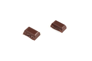 Close-up pieces of chocolate bar with filling isolated on white background.