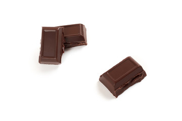 Close-up pieces of chocolate bar with filling isolated on white background.