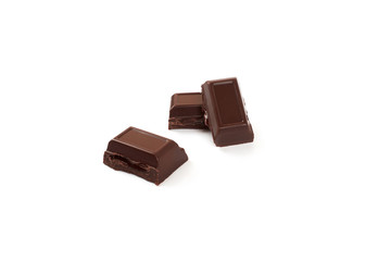 Close-up pieces of chocolate bar with filling isolated on white background.