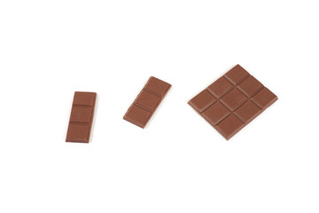 pieces of milk chocolate bar isolated on white background.