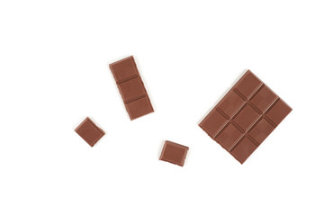 pieces of milk chocolate bar isolated on white background.