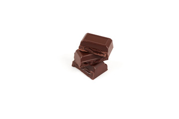 Close-up pieces of chocolate bar with filling isolated on white background.