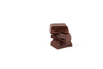 Close-up pieces of chocolate bar with filling isolated on white background.