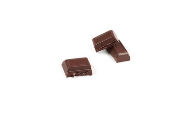 Close-up pieces of chocolate bar with filling isolated on white background.
