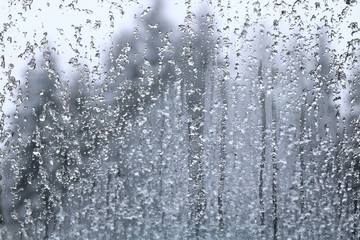 Frozen drops and snow on frosted glass