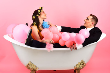 Your hair care routine. Couple of mime man and sexy woman enjoy bathing. Couple in love in bath...