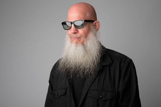 Face Of Mature Bald Bearded Man With Sunglasses Thinking And Looking Away