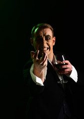 Hate. Comedian with mime makeup hold wine glass. Mime man. Mime artist perform on stage. Stage...