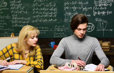 Concept education - back to school on green background. Teenage female student preparing for exams at college classroom. Final exam test in university students study for examination in classroom.