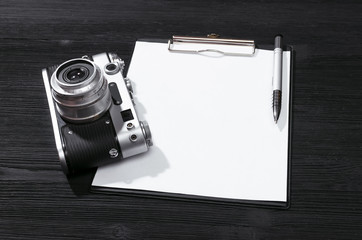 Shot list mockup. Photo session contract template. Vintage film photo camera and blank paper page...