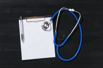 Medical insurance mockup. Medical receipt or history template. Health examination results. Stethoscope and blank page with copy space on a black table background. Top view.