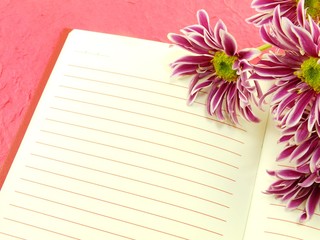 open notebook and beautiful chrysanthemums pink flowers bouquet