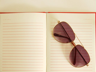 open notebook and sunglasses