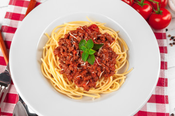 Pasta with meat, tomato sauce and vegetables on the table