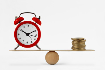 Clock and money on scales - Balance between time and money, time is money concept