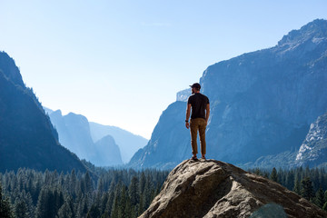 Hiker On Top of Mountain - Looking out at Vast Yosemite National Park