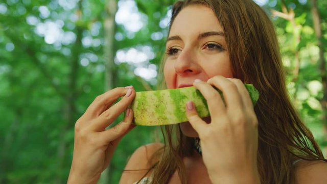 Young woman eating watermelon