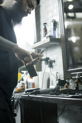 The male hands and tools for cutting beard at barbershop. Vintage tools of barber shop