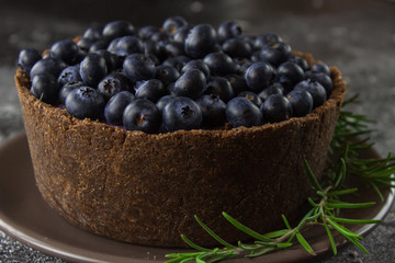 Blueberry vegan cheesecake. Dark photo on black background