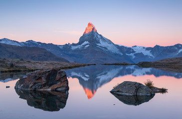 The famous Matterhorn reflected in the Stellisee during dawn. Zermatt, Switzerland.