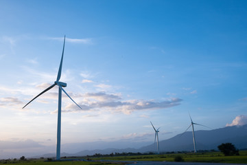 Wind turbine farm or windmill on blue sky. Turbine green energy electricity or wind turbine in a green field - Energy Production with clean and Renewable Energy. Phan Rang, Vietnam