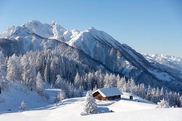  Beautiful winter mountain landscape with snowcapped wooden hut