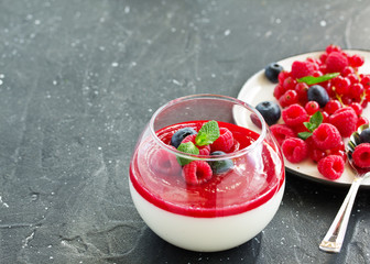 Delicious Italian dessert panna cotta with berries and berry sauce. Valentine's Day.