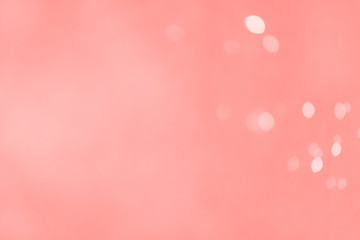 Banner with color of the year 2019 - Living Coral. Christmas light background. Holiday glowing backdrop. Blurred Bokeh.