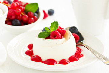 Delicious Italian dessert panna cotta with berries and berry sauce. Valentine's Day.