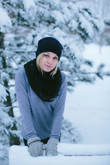 happy young woman in winter park for a walk in nature