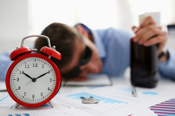 Businessman in blue shirt asleep at work