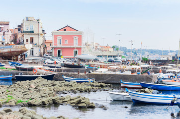 Fototapeta na wymiar Acitrezza port with fisher boats next to Cyclops islands, Catania, Sicily, beautiful seafront