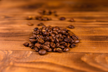 Pile of the coffee beans on wooden table