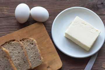 rye bread with butter and boiled eggs on the village table