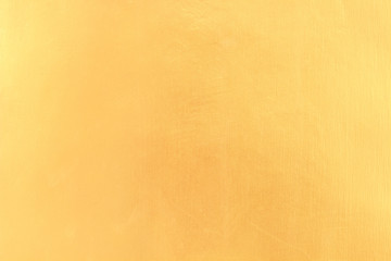 Gold paint on cement wall texture.