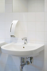 Public bathroom in the airport or restaurant, cafe. Bathroom interior sink with modern design. Interior of bathroom with washbasin and faucet. Close-up of bathroom. White bathroom.