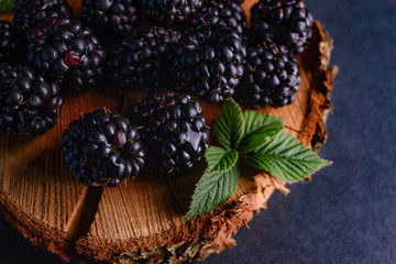 BlackBerry on a dark background with a green leaf