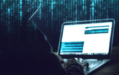 Mann mit Kapuzenpullover beim Hacken