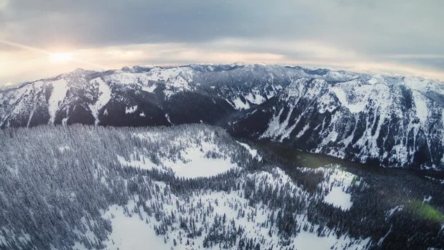 Epic Mountain Range Aerial Background with Winter Snow Flakes Falling
