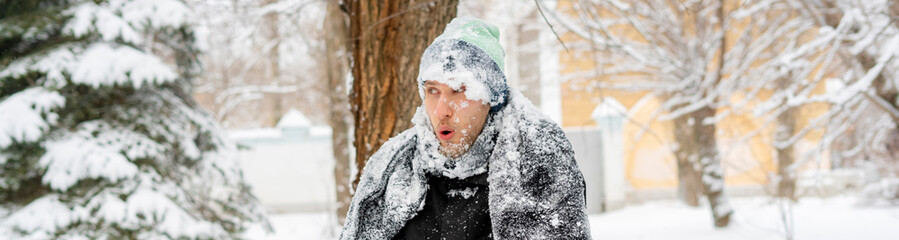 close up portrait of frost man face covered by snowy scarf and hat outdoor, winter concept f