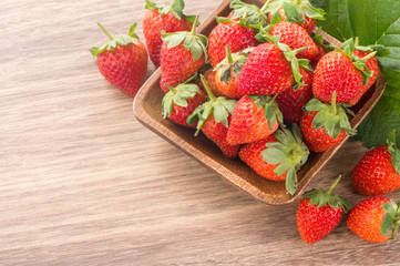 A plate of beautiful strawberries isolated on wooden background, close up, macro.