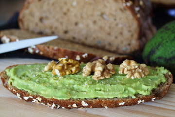 Avocado on toast bread with nuts. Horizontal image.