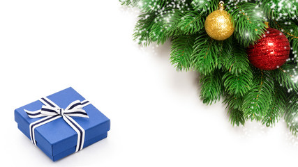 Christmas holidays decoration with blue gift box and fir branches isolated on white background