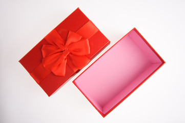 Open gift box with red ribbon
