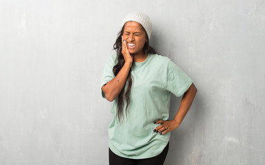 Young afro american woman on textured background with toothache