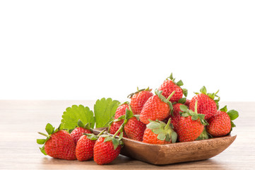 A plate of beautiful strawberries isolated on wooden background, close up, macro.